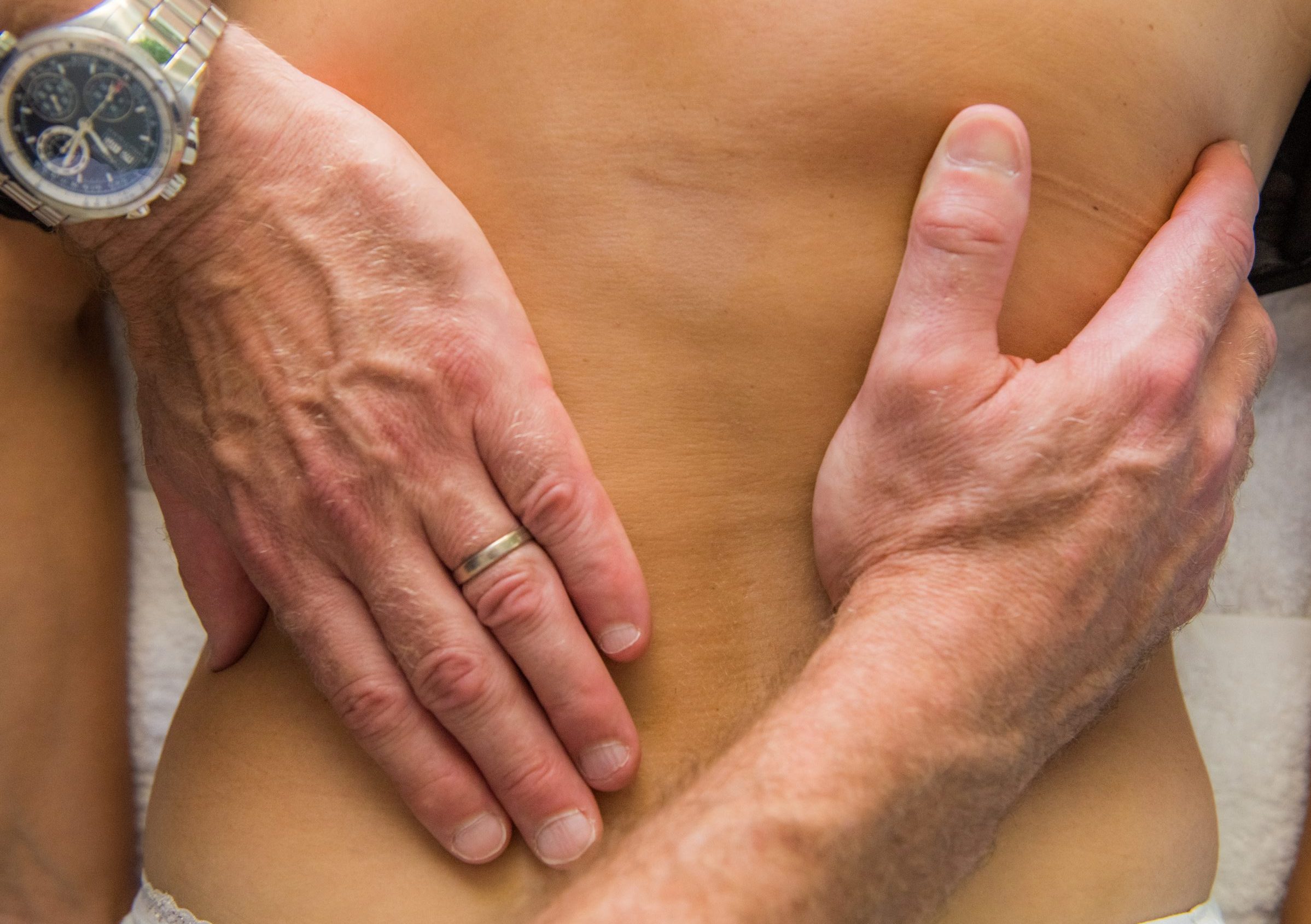 Osteopath conducting an initial assessment to understand the patient's current situation."